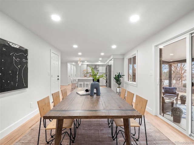 dining space featuring recessed lighting, baseboards, and light wood-style floors