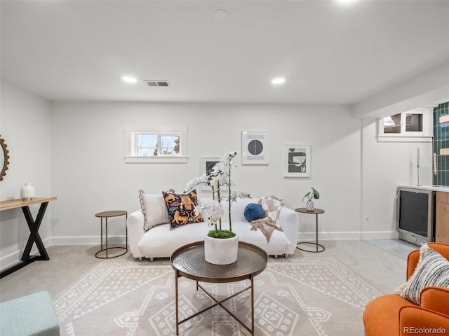 living room with light carpet, visible vents, recessed lighting, and baseboards