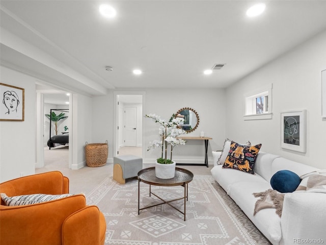 carpeted living area featuring recessed lighting, visible vents, and baseboards