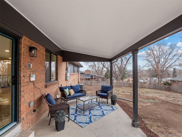 view of patio / terrace featuring outdoor lounge area and fence