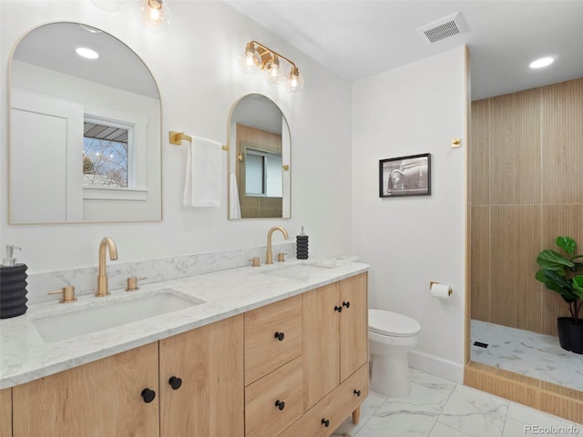 bathroom featuring visible vents, marble finish floor, toilet, and a sink