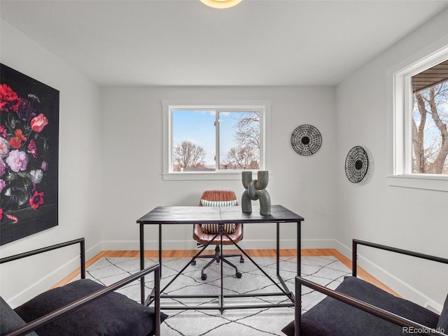 office space featuring baseboards and wood finished floors