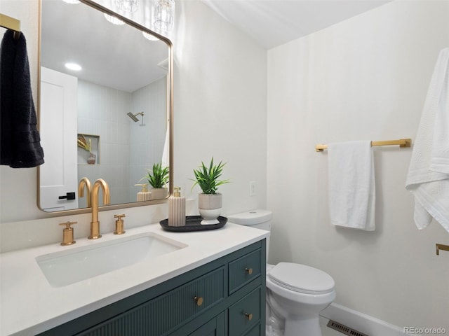 full bathroom with visible vents, toilet, walk in shower, and vanity