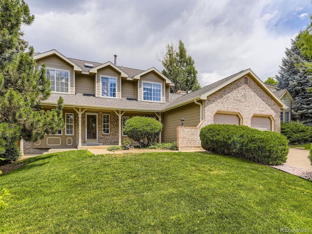 15035 E Grand Ave, Aurora, CO 80015 - view of front of property featuring brick siding, an attached garage, and a front lawn