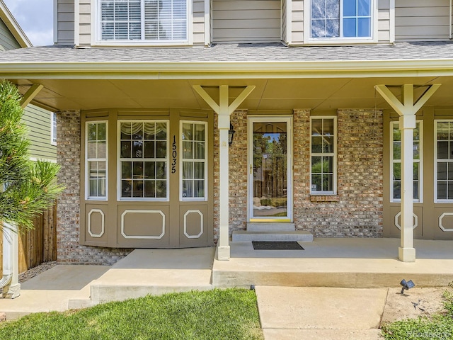 15035 E Grand Ave, Aurora, CO 80015 - view of exterior entry featuring a porch and brick siding