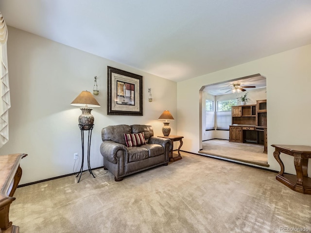 15035 E Grand Ave, Aurora, CO 80015 - living area with ceiling fan, carpet, and arched walkways