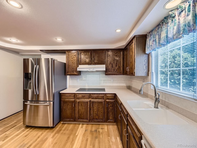 15035 E Grand Ave, Aurora, CO 80015 - kitchen with stainless steel refrigerator with ice dispenser, under cabinet range hood, light countertops, dark brown cabinets, and black electric cooktop