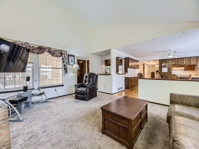 15035 E Grand Ave, Aurora, CO 80015 - living room with light carpet, ceiling fan, and high vaulted ceiling