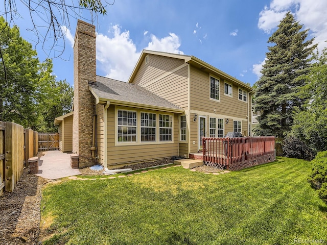 15035 E Grand Ave, Aurora, CO 80015 - back of house featuring a chimney, a wooden deck, and a fenced backyard