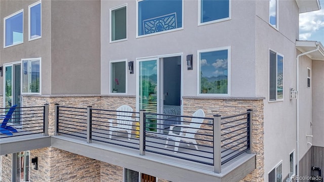 entrance to property with stone siding and stucco siding