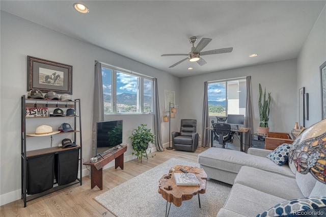 living area featuring light wood-type flooring, baseboards, a ceiling fan, and recessed lighting