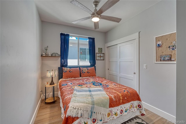 bedroom with ceiling fan, baseboards, and wood finished floors