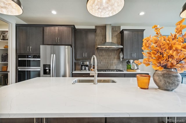 3251 Virga Loop, Colorado Springs, CO 80904 - kitchen with stainless steel fridge with ice dispenser, wall chimney range hood, a sink, double wall oven, and gas cooktop