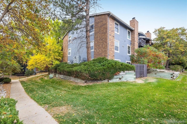 view of side of property with a yard