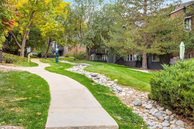 view of property's community featuring a yard