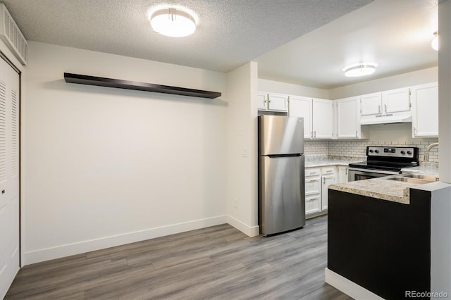 kitchen featuring light hardwood / wood-style floors, white cabinetry, and stainless steel appliances