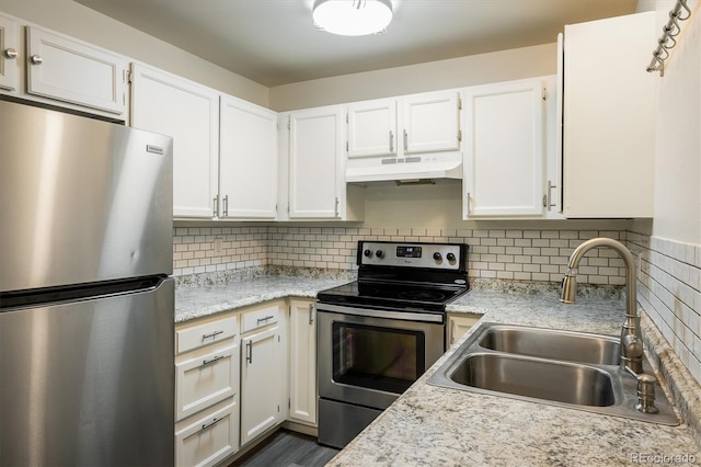 kitchen featuring white cabinets, appliances with stainless steel finishes, decorative backsplash, and sink