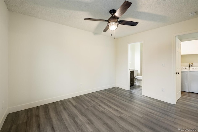 spare room with independent washer and dryer, a textured ceiling, ceiling fan, and dark wood-type flooring