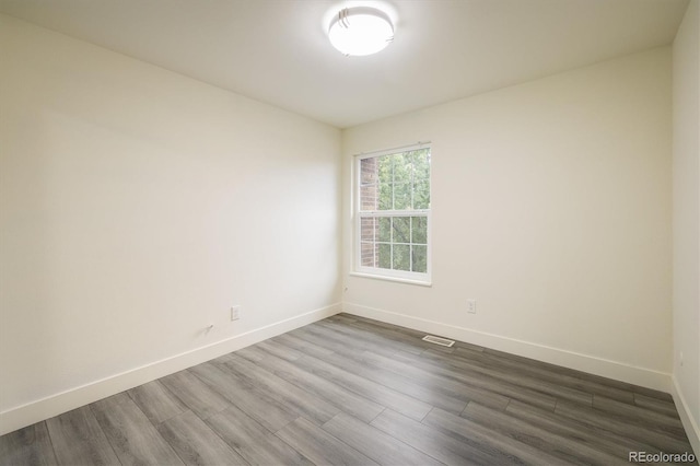 spare room featuring hardwood / wood-style flooring