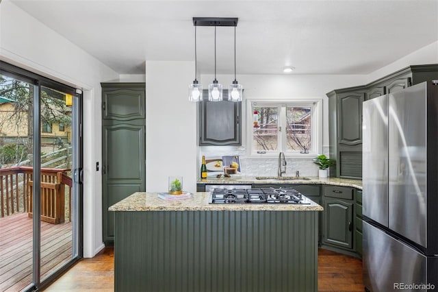 kitchen featuring light stone countertops, appliances with stainless steel finishes, dark wood finished floors, and a sink