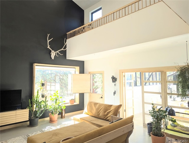 living room featuring a towering ceiling