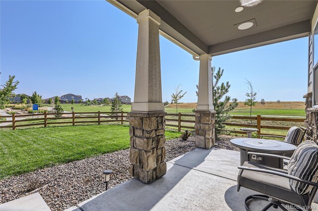 view of patio / terrace featuring a rural view and fence