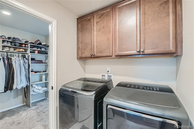 laundry room featuring baseboards, cabinet space, separate washer and dryer, and carpet