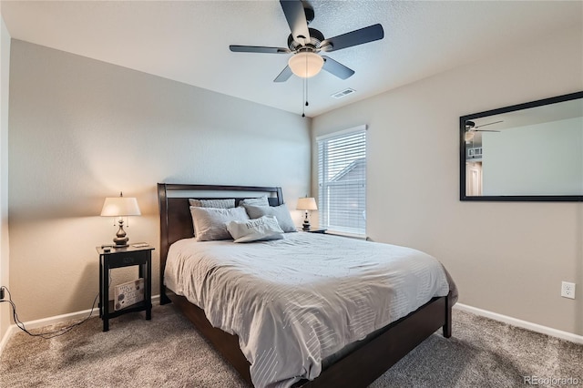 bedroom with visible vents, carpet floors, baseboards, and ceiling fan