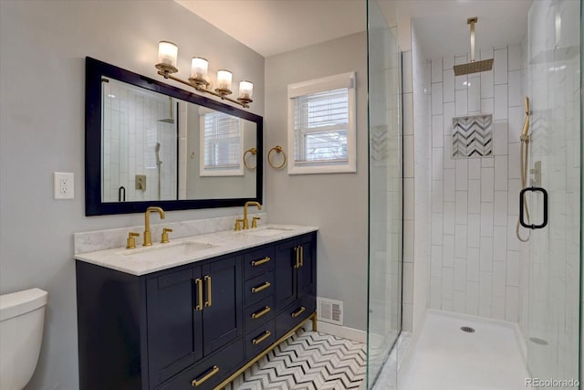 bathroom with a sink, visible vents, toilet, and a shower stall