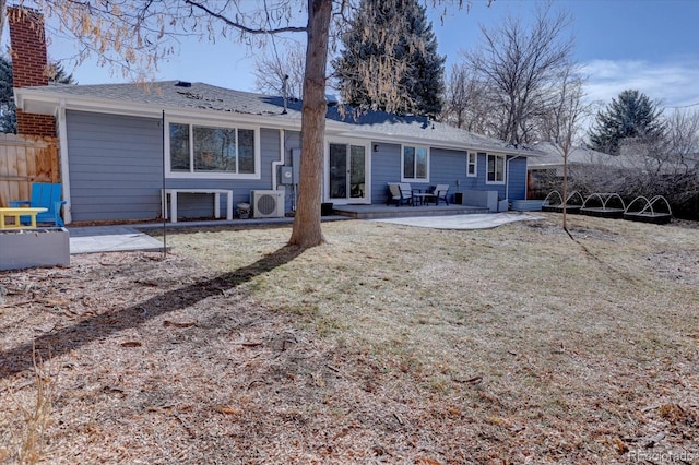 rear view of house with a patio, a yard, ac unit, and fence