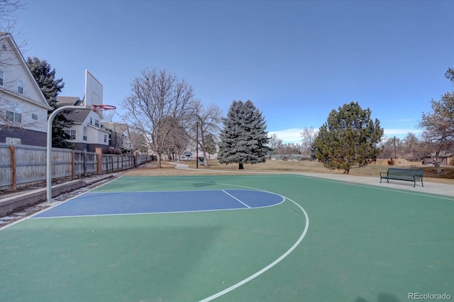 view of basketball court with community basketball court and fence