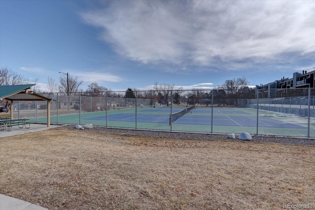 view of tennis court featuring fence