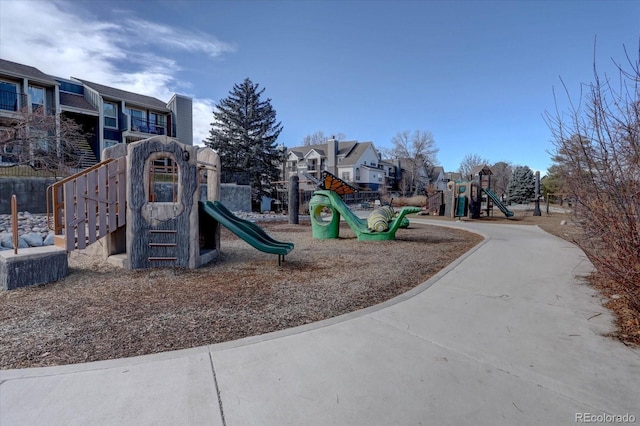 communal playground featuring a residential view