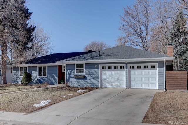 ranch-style home with fence, roof with shingles, driveway, a chimney, and a garage