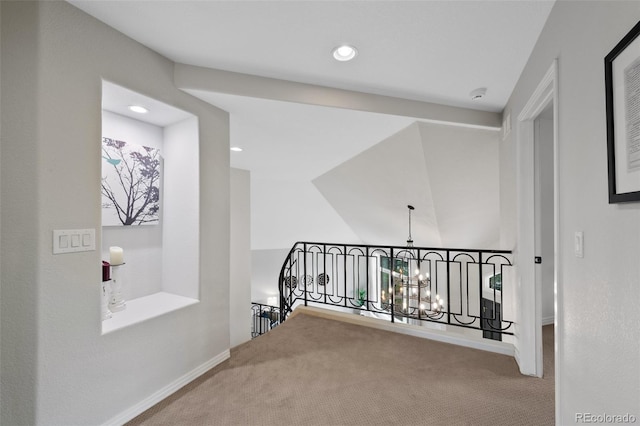 corridor with recessed lighting, carpet flooring, an upstairs landing, baseboards, and an inviting chandelier