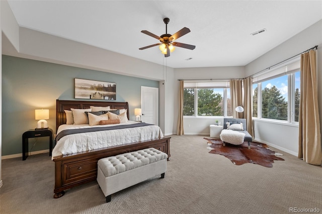 carpeted bedroom with ceiling fan, visible vents, and baseboards