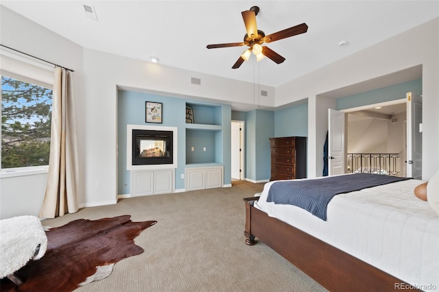 carpeted bedroom featuring visible vents, baseboards, and ceiling fan