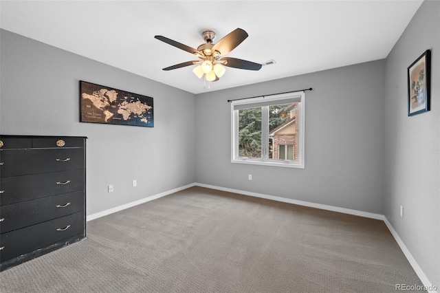 unfurnished bedroom featuring ceiling fan, carpet flooring, visible vents, and baseboards