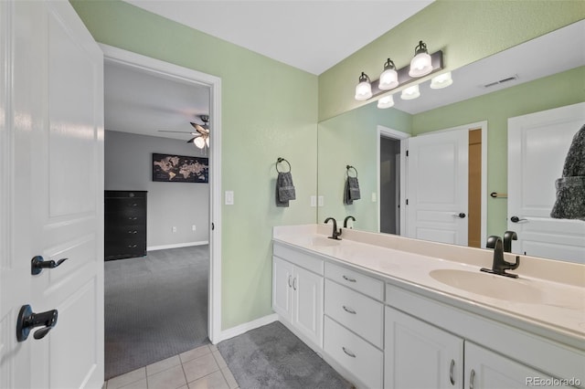 bathroom with double vanity, visible vents, a sink, and tile patterned floors