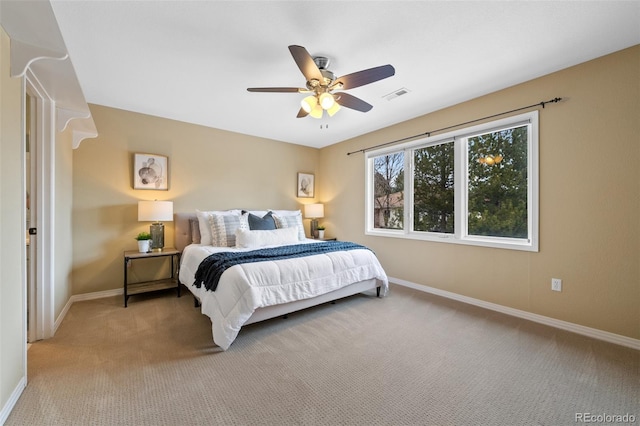 bedroom with baseboards, visible vents, and light colored carpet