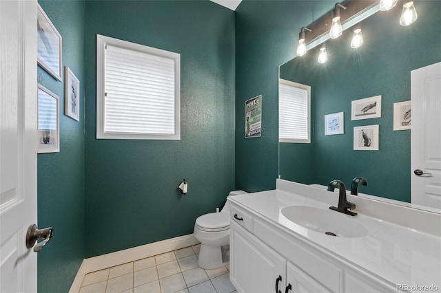 half bath featuring tile patterned flooring, baseboards, vanity, and toilet