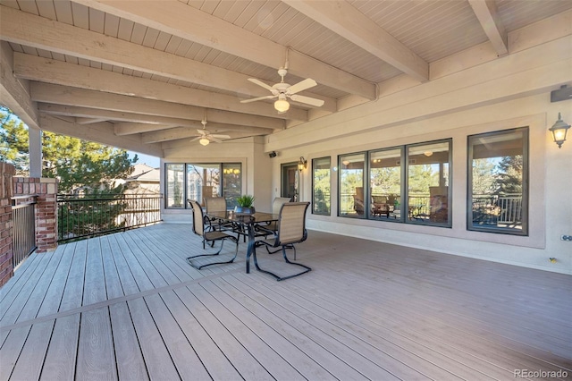 wooden terrace with a ceiling fan and outdoor dining area