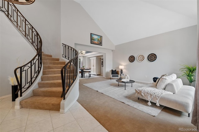 living room with high vaulted ceiling, tile patterned flooring, carpet flooring, baseboards, and stairway