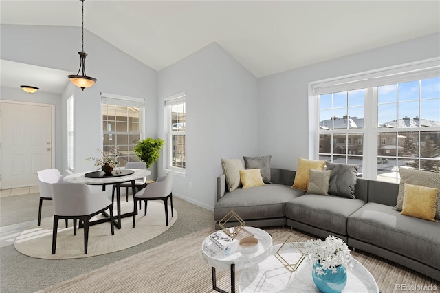 carpeted living room with vaulted ceiling