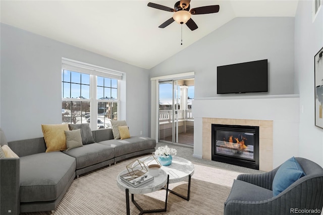 carpeted living room featuring ceiling fan, lofted ceiling, and a fireplace