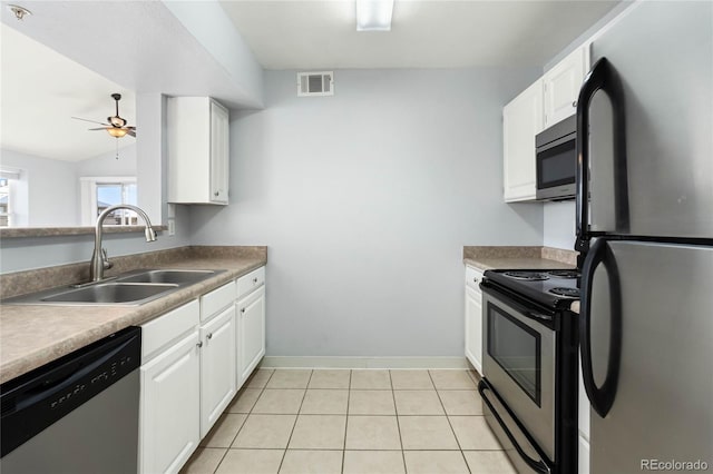 kitchen featuring sink, white cabinets, vaulted ceiling, and appliances with stainless steel finishes