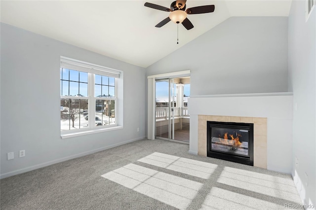 unfurnished living room featuring a tile fireplace, light colored carpet, high vaulted ceiling, and ceiling fan