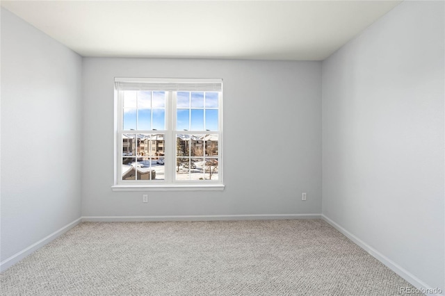 spare room featuring light colored carpet