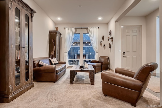 sitting room with light carpet and recessed lighting