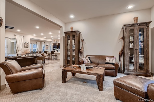 living room with recessed lighting and light colored carpet